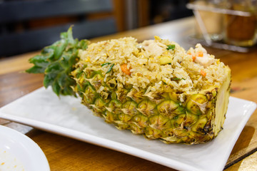 Fried rice served inside a hollowed out pineapple, Thailand.