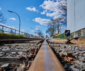 Low angle shot along a railroad track of a railroad line for freight trains in an industrial area...