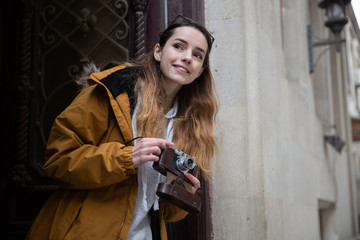 Photo of young tourist girl exploring streets of Baku. Moody photos of teenager girl visiting old city and taking photos of the city