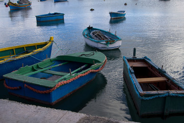 Fototapeta na wymiar the colorful boats of Marsaxlokk harbor