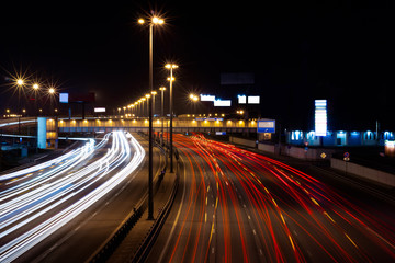 Traffic in motion on a long exposure on a night highway in the city.