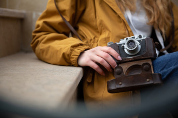 Photo of young tourist girl exploring streets of Baku. Moody photos of teenager girl visiting old city and taking photos of the city