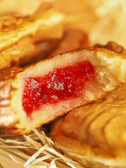 Filling of sweet waffles closeup. bitty pancake with mouth-watering internal jam. traditional japanese dessert tayaki.