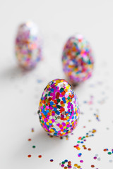 Glitter easter eggs on white background