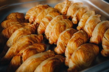 Set of coffee break in the hotel during conference meeting, with tea and coffee catering, decorated catering banquet table with variety of different pastry and bakery, with croissants and cookies