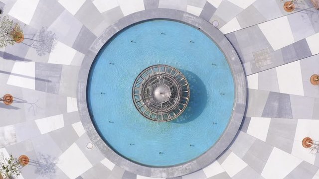 Corona Virus lockdown, Tel Aviv Dizengoff square, Aerial top down pull up spin shot from fountain to full general view or the square and surrounding buildings during Government lockdown guidelines.