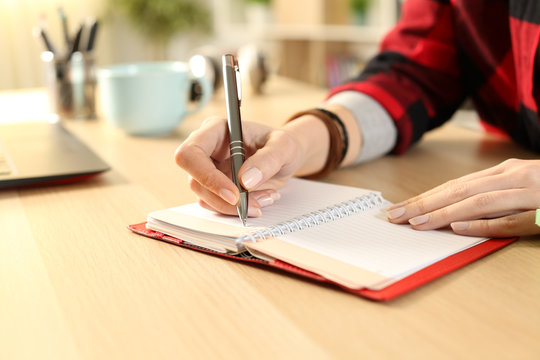 Student girl hands writing reminder on agenda