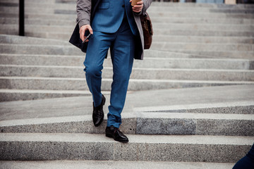 Male in stylish shoes walking down the steps