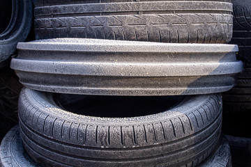 Frosty scrap car tyres ready to be recycled, landscape view