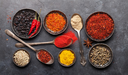 Various spices in bowls and spoons