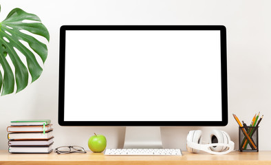 Stylish home studio workspace with computer, supplies and headphones