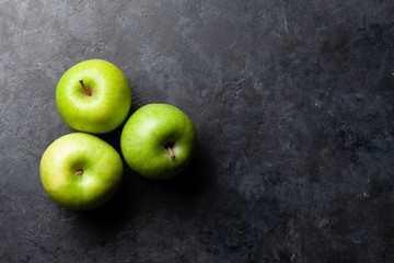 Ripe green apple fruits on dark stone table