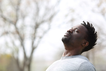 Black man breathing fresh air outdoors in winter