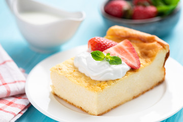 Slice of ricotta cake or casserole on white plate, closeup view. Tasty homemade curd cheese or cottage cheese cake