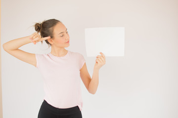 Young beautiful girl with pink shirt and white paper