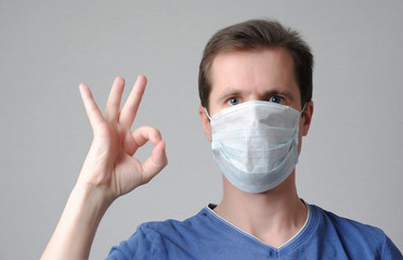 man in medical mask shows ok gesture. poster concept