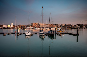 Fototapeta na wymiar Sailing boats in the marina of Zeebrugge during blue hour. Long exposure image
