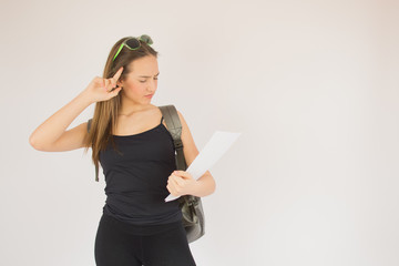 Young beautiful schoolgirl with glasses and bag