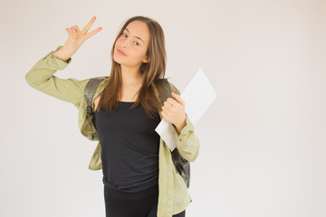 Young beautiful schoolgirl with green jacket and bag