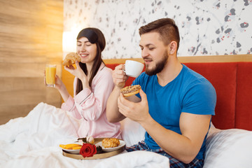 Romantic couple, breakfast in bed, caring husband