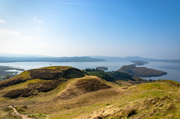 Fototapeta na wymiar View from Conic hill in Scotland. Beautiful mountains with lake.
