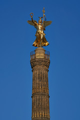Fototapeta na wymiar close-up of the Goldelse, the Statue of St. Victoria on the Victory Column, Tiergarten, Berlin city, Germany on a sunny day with a beautiful blue sky