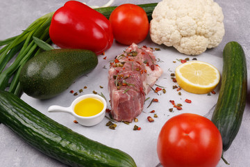 Fresh meat and vegetables for cooking your favorite dishes on a light background