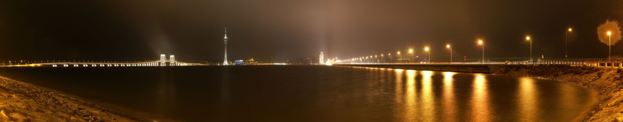 Fototapeta premium Night view of the Governador Nobre de Carvalho Bridge and Macau Tower Convention and Entertainment Center