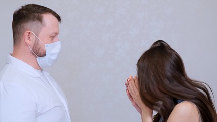 sick woman has flu or cold symptoms and sneezes in the presence of a doctor. 