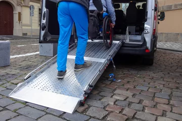 Fotobehang Assistant helping disabled person on wheelchair with transport using accessible van ramp © 24K-Production
