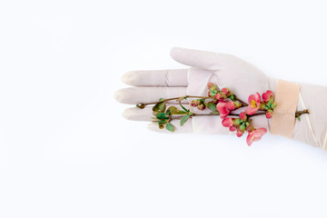 Obraz na płótnie Canvas pink flower adhesive tape hand medical covid 19 glove patch white background
