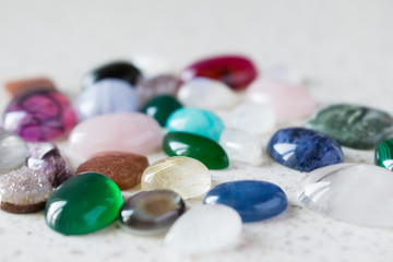 Multicolored polished stones for making jewellery. Colorful cabochons for jeweller.