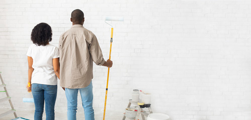 African american family paints walls without repairman