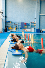 Female swimmers, aqua aerobics at the poolside