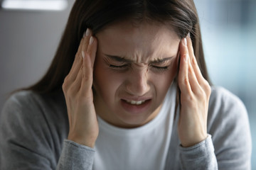 Unwell young woman touch massage temples suffer from headache or migraine, unhappy unhealthy...