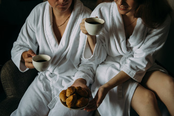 Morning at the hotel: lovers drink coffee with croissants - 335907682