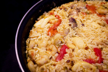 Rice paella cooked with chicken, seafood and vegetables