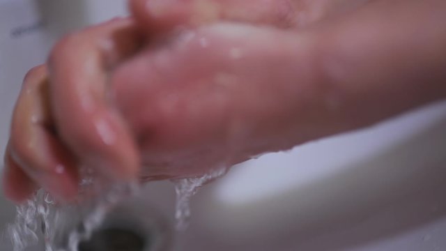 a man washes his hands for disinfection