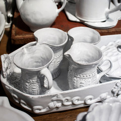 White porcelain jugs in a white tray as decoration for the kitchen