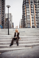 Caucasian female entrepreneur sitting on the staircase