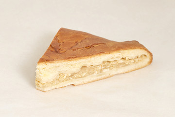 Pie stuffed with kapusty eggs. Fresh pastries. Closeup on a light background