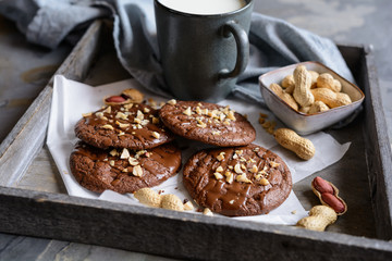 Brownie cookies topped with melted chocolate and chopped peanuts
