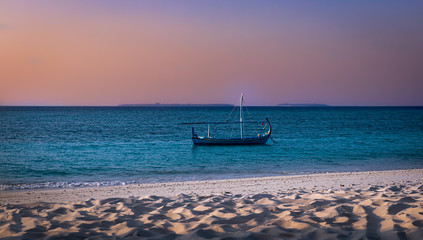 boat on the beach at sunset