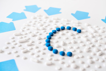 Concept of health care, medicine, pharmacy, COVID-19, coronavirus. Treatment and prevention of diseases. Assortment of medicinal pharmaceutical products, white and blue pills with a c shape.