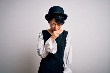 Young beautiful asian girl wearing casual dress and hat standing over isolated white background feeling unwell and coughing as symptom for cold or bronchitis. Health care concept.