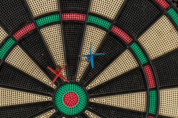 Red and blue dart arrrow hitting in the target.Darts sport concept
