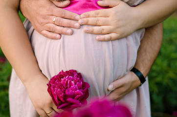 Hands holding pregnant belly
