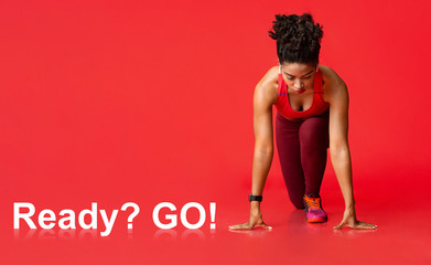Ready To Start. Sporty black woman on starting position before run