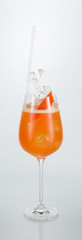 Close up of a hand holding a glass of Singapore cocktail on white background with copy space.
