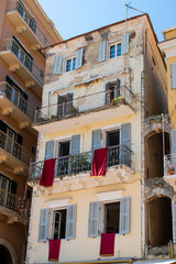 Fototapeta na wymiar Traditional easter holidays in Corfu island, Greece. Windows and balconies at Liston Square in Kerkyra.